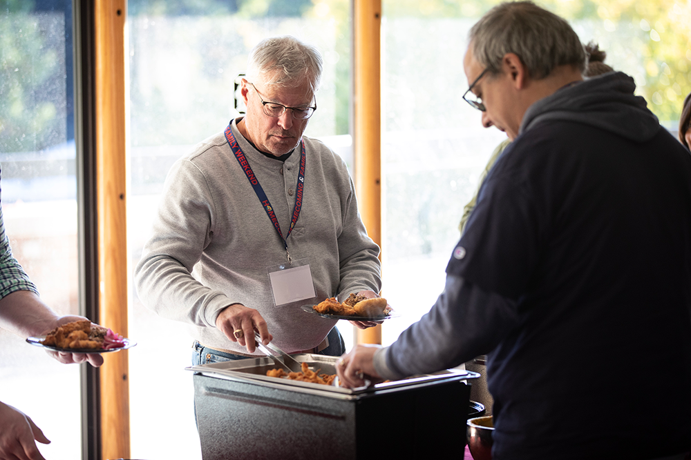 Duquesne alum fills his plate of food