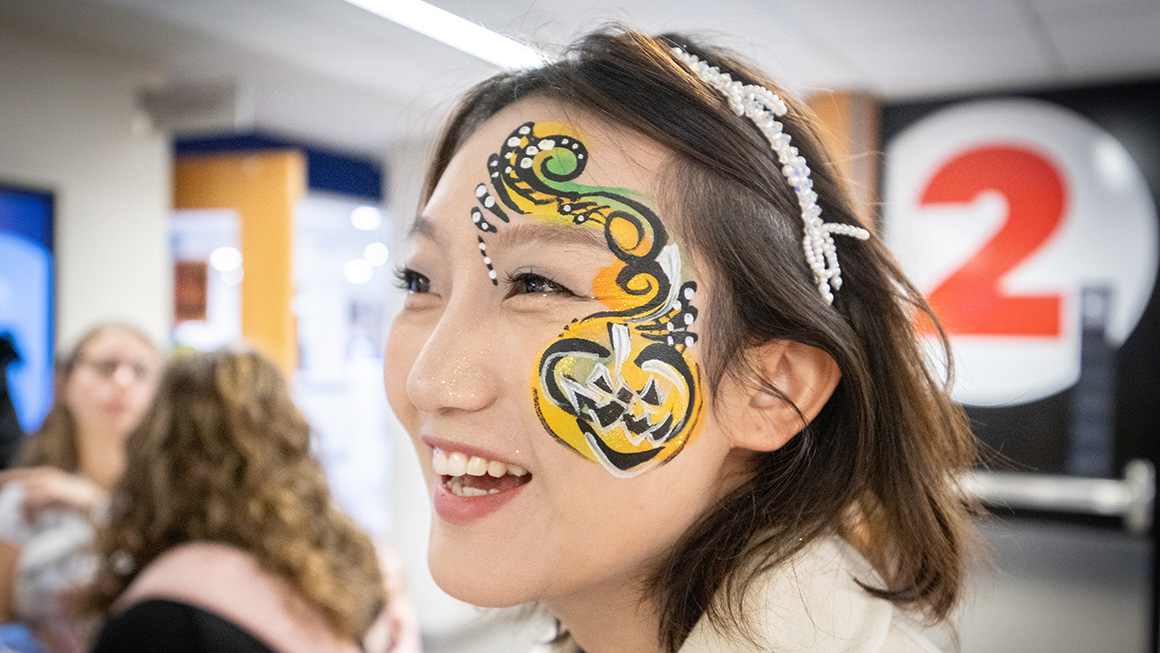 A Duquesne student with festive Halloween face paint