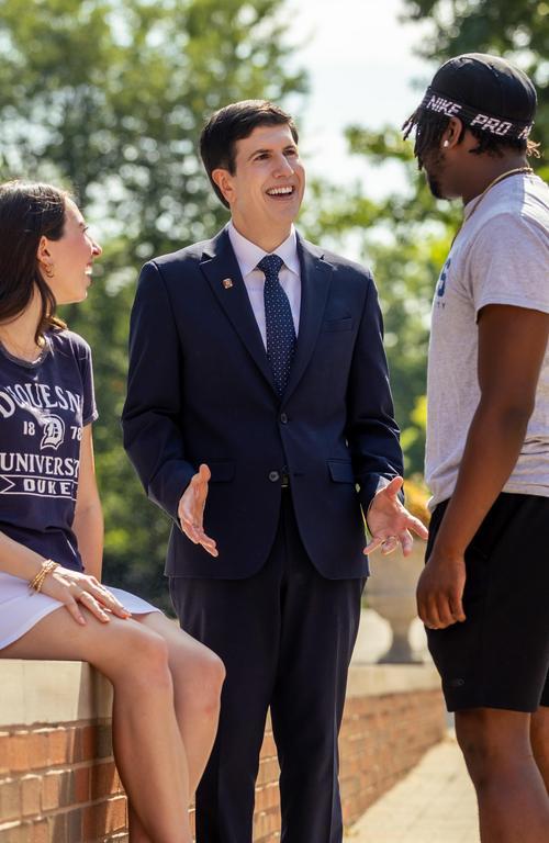 President Dr. David J. Dausey talking with DU studednts