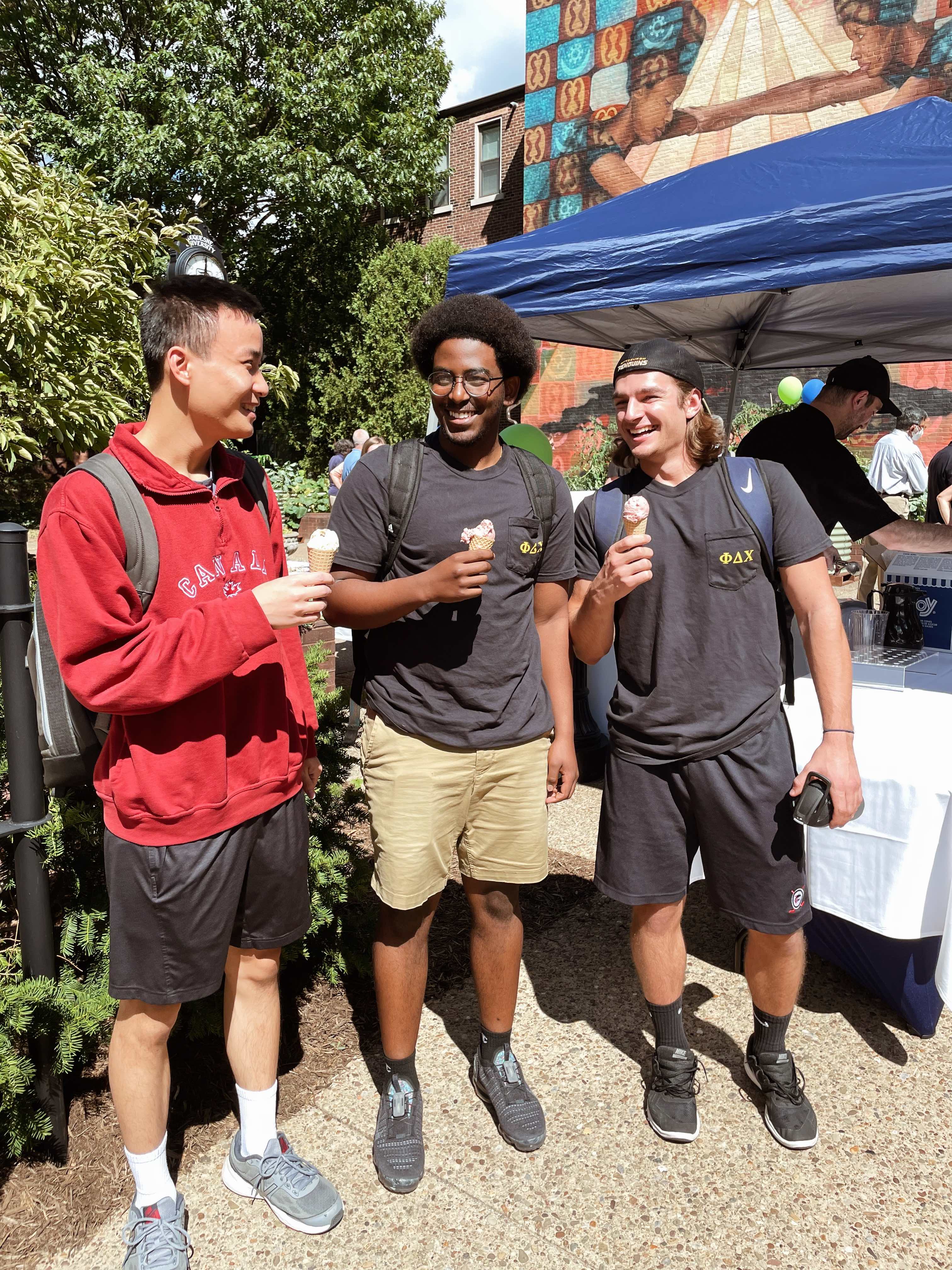 three students having ice cream on a-walk