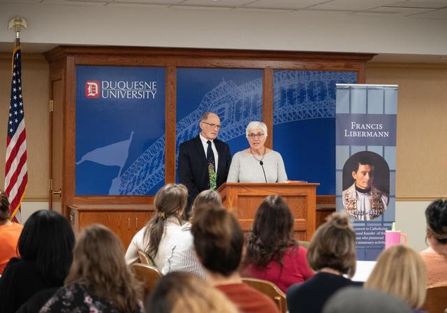 Attendees listen to a presentation during Founders Week.
