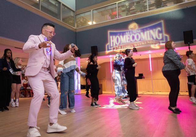 Students and families dance together in the Union Ballroom for Homecoming and Spirit Week.