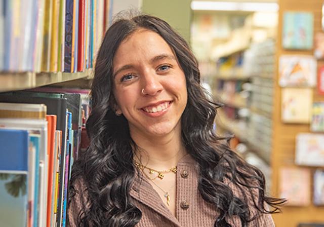 Headshot of Cat Veneziano in front of bookshelf in Duquesne's Curriculum Center