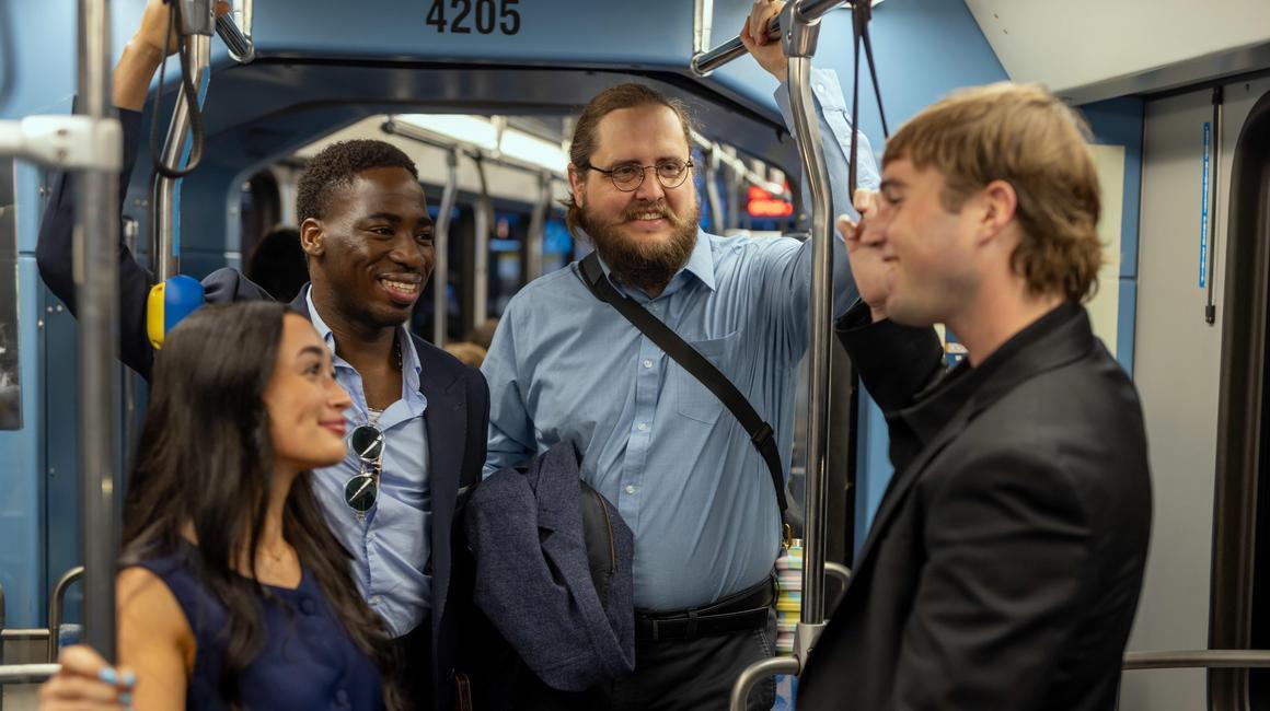 Ben Osmann and classmates engage in conversation on the Pittsburgh Regional Transit's light rail.
