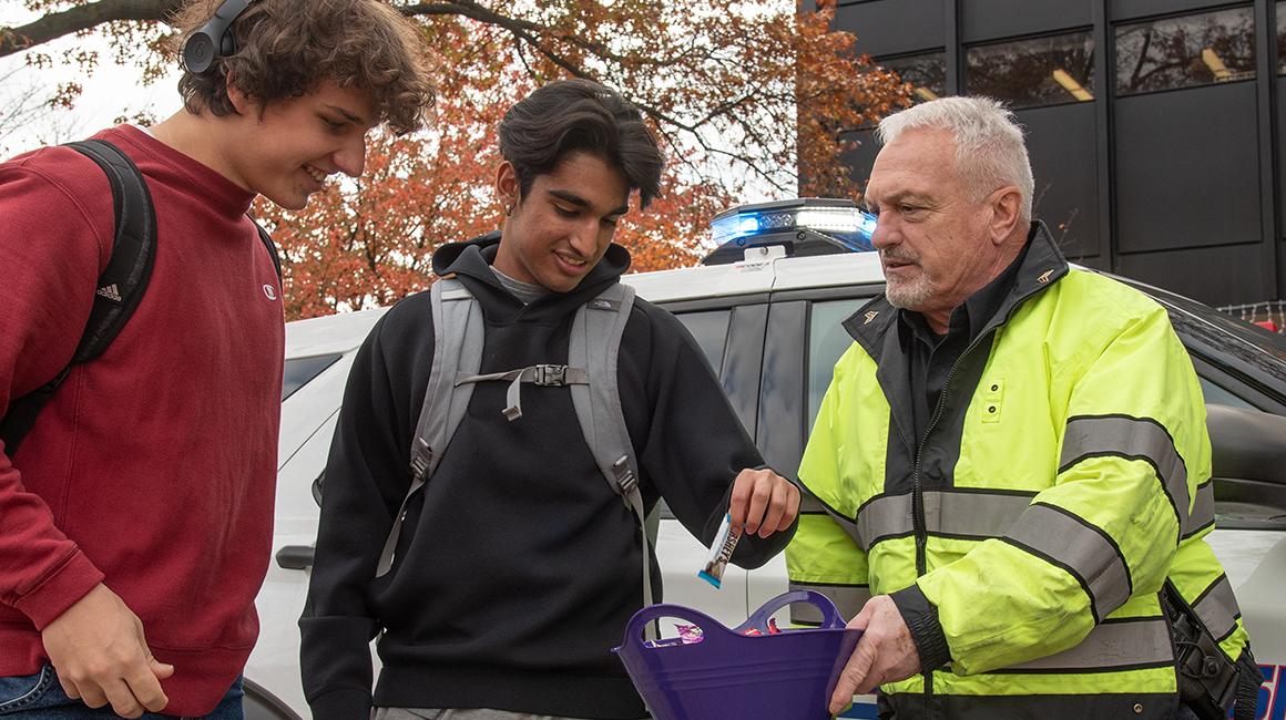Campus public safety sargent shares Halloween candy with students