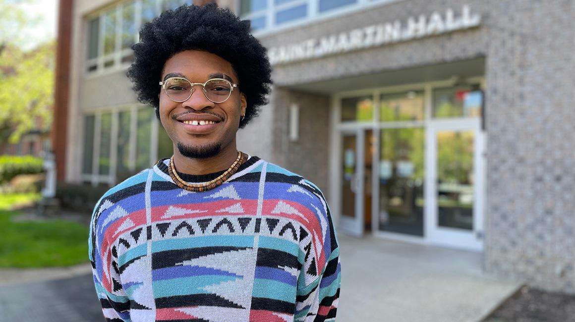 Resident director Micah White stands outside of St. Martin Hall on Duquesne's campus