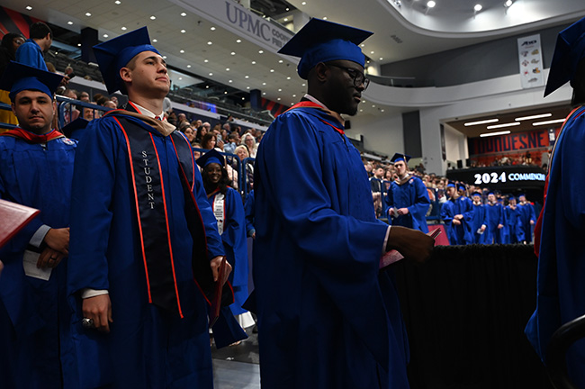 Jeromy wears his cap and gown while attending commencement in 2024