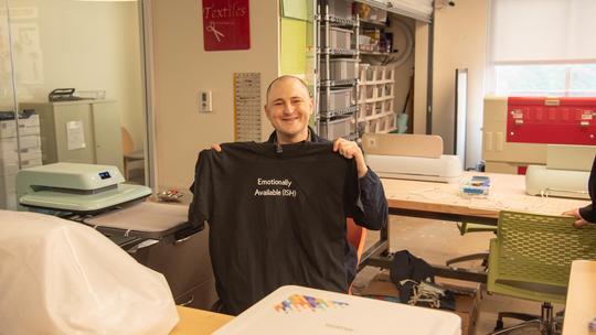 Luke Poljak holds up a shirt he helped to create as part of a Valentines-themed line.