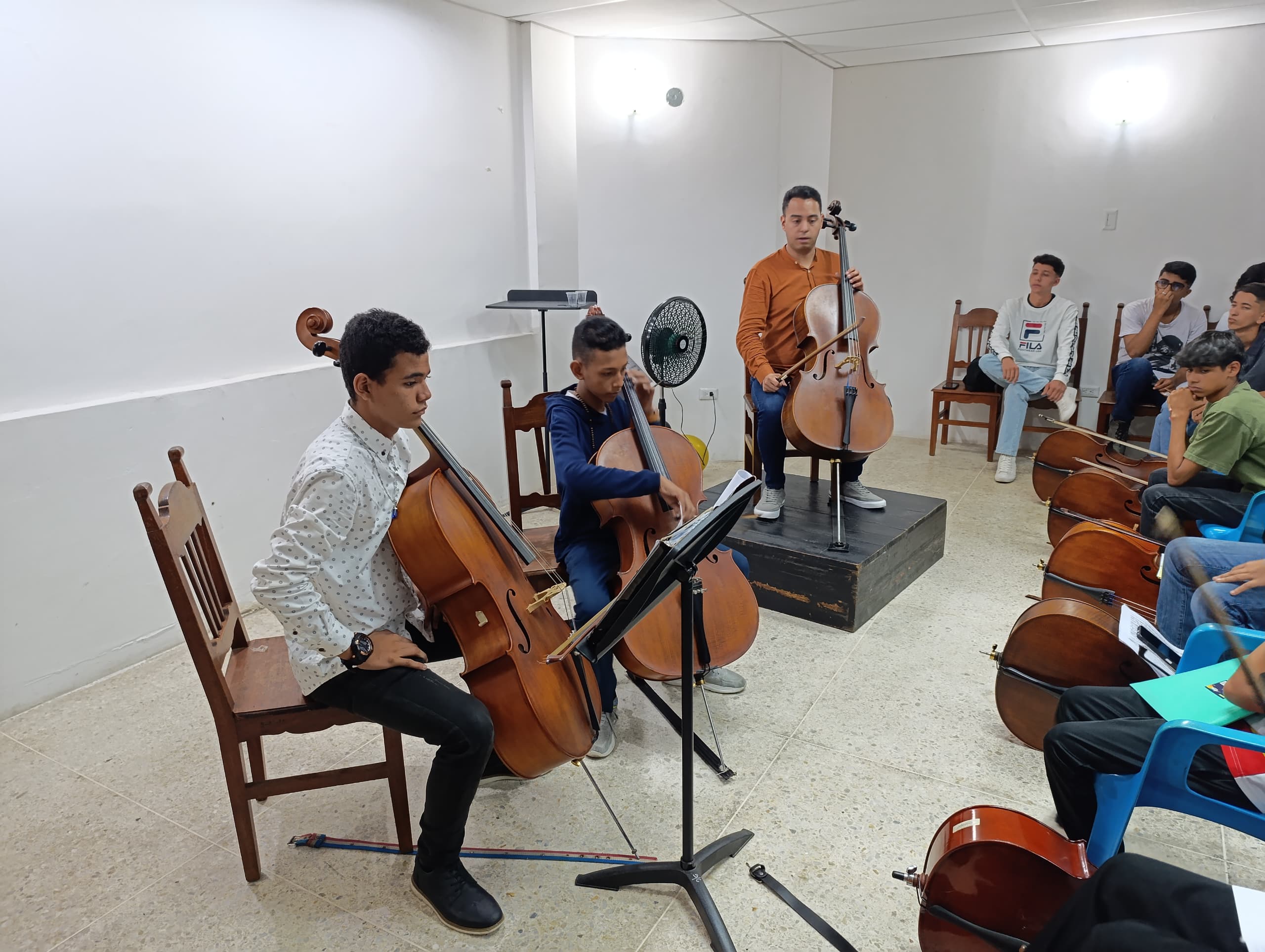 William Garcia with young cellists and their instruments