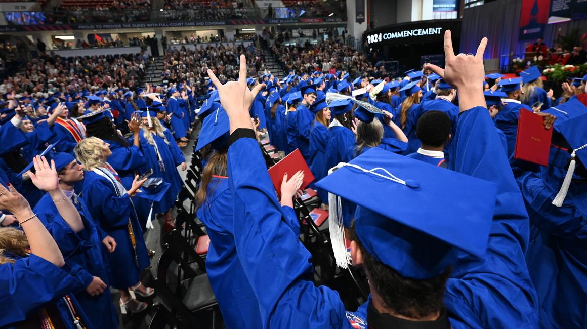 Duquesne students wearing caps and gowns celebrate at the 2024 commencement ceremony