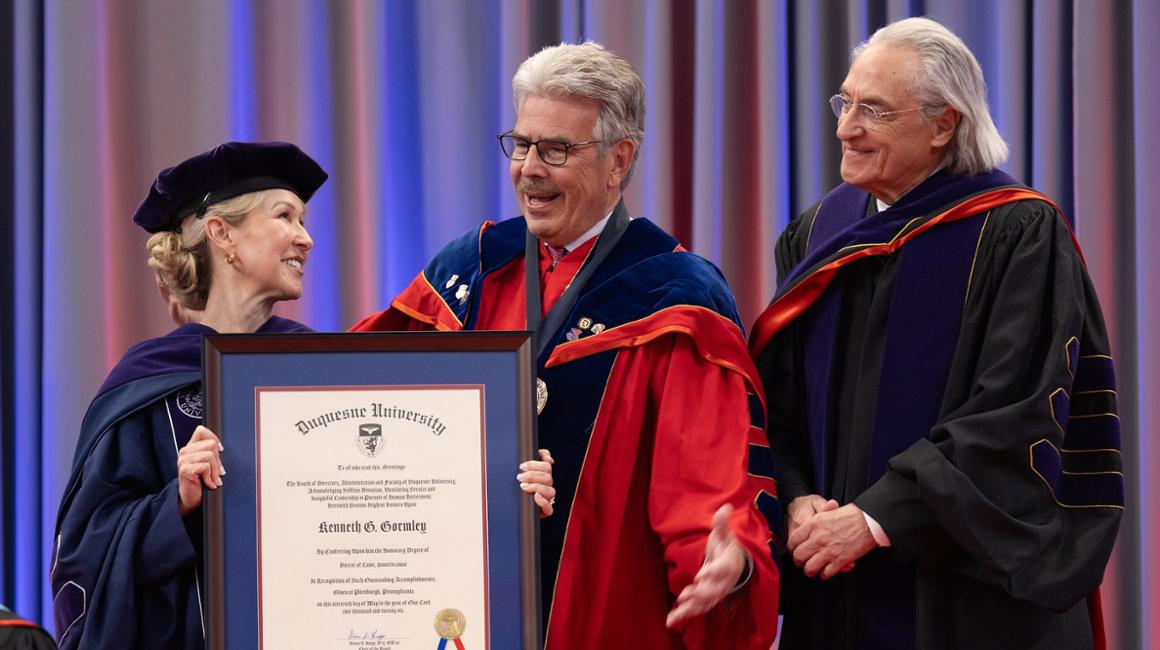 Law Dean presenting honorary degree to University President