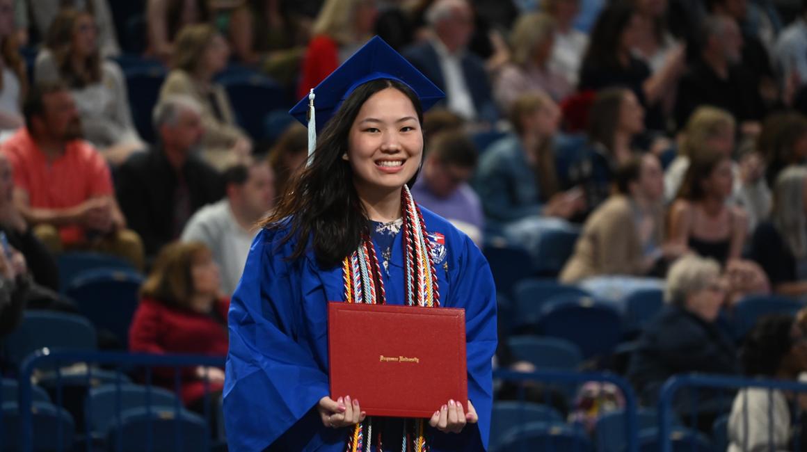 Female graduate holding diploma