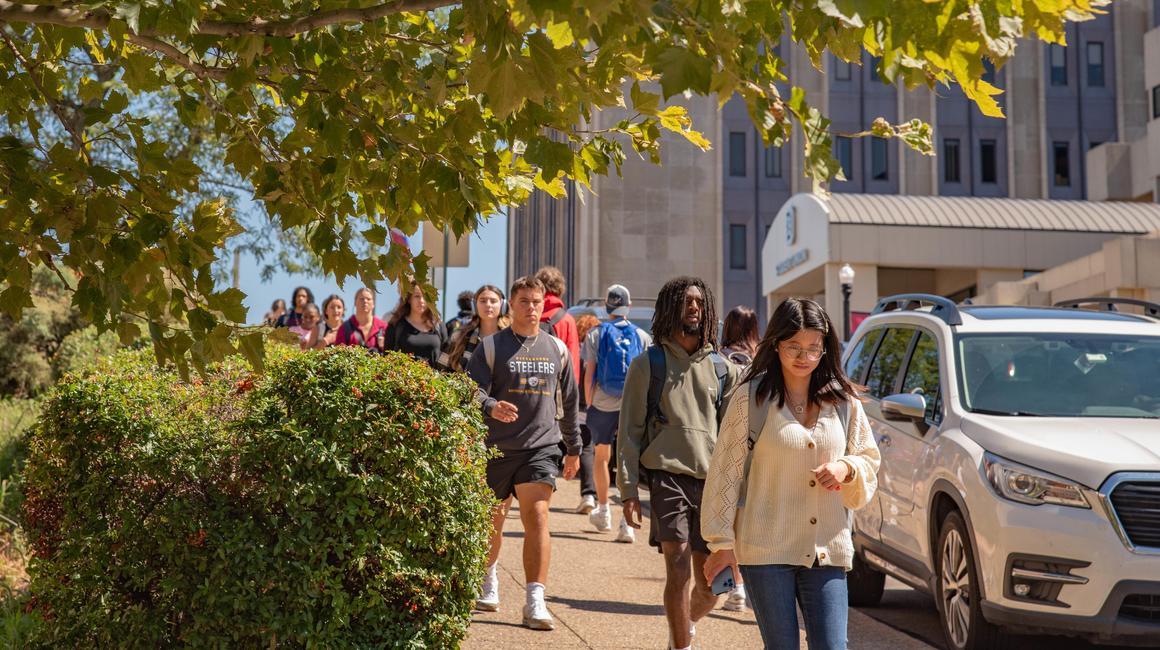 Students walk on Duquesne's campus during the early fall semester