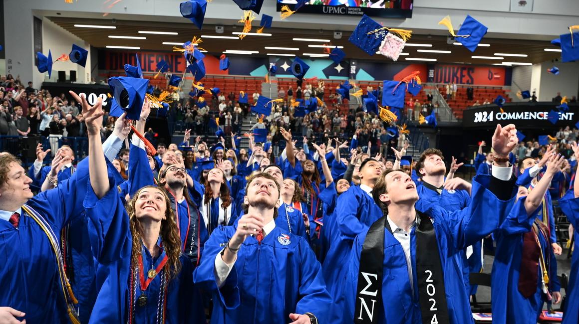 Graduates throwing caps in the air