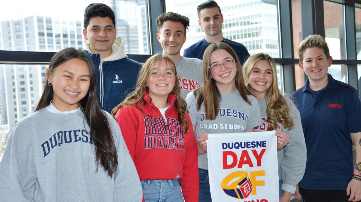 Students with Day of Giving Sign