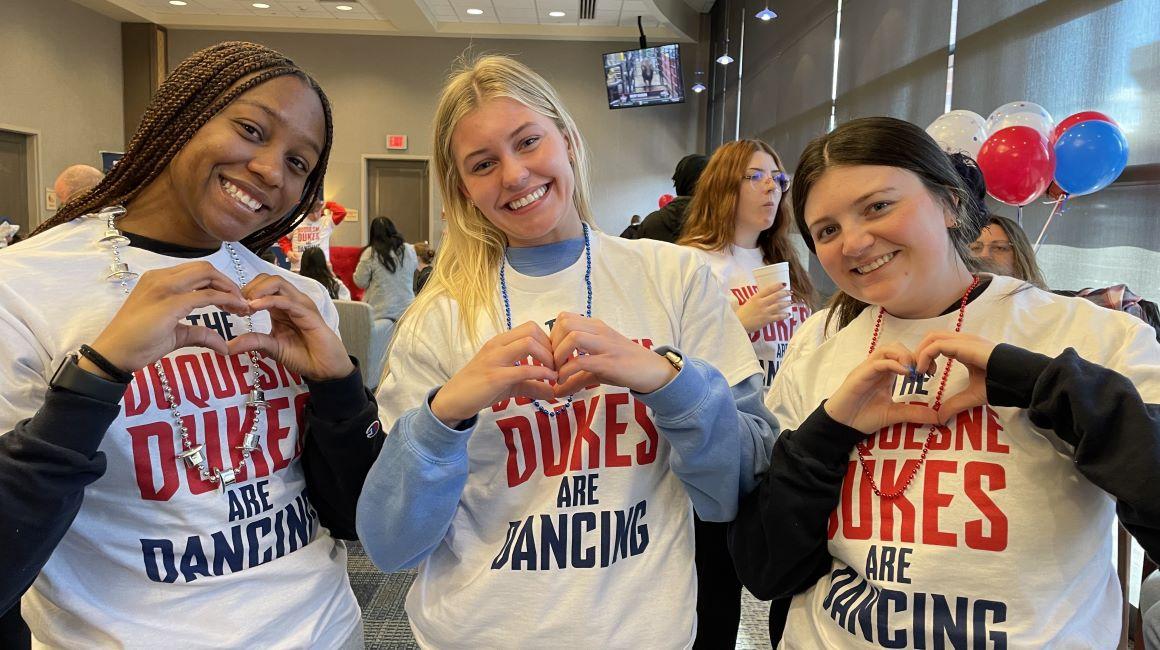 Duquesne students flash their heart hands during heart month, February.