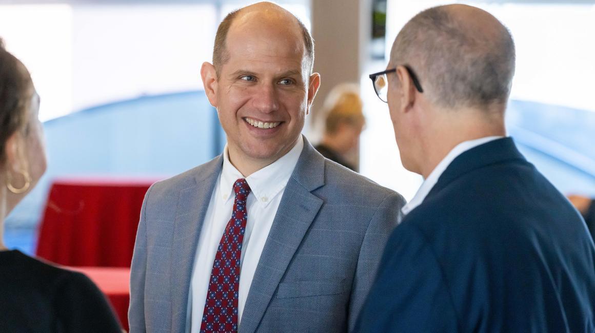 Dr. John Kern socializes with colleagues at an event on campus