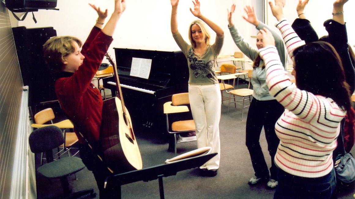 Music students learning music therapy techniques.