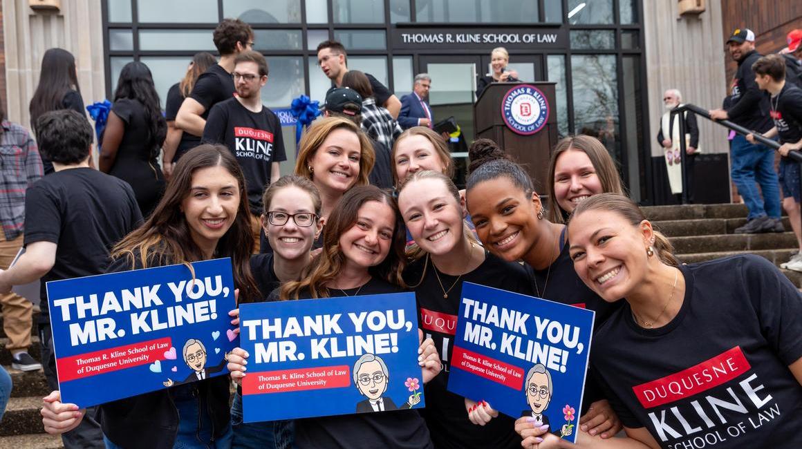 Law students with "Thank You, Mr. Kline!" signs at the Law School Re-Dedication Ceremony