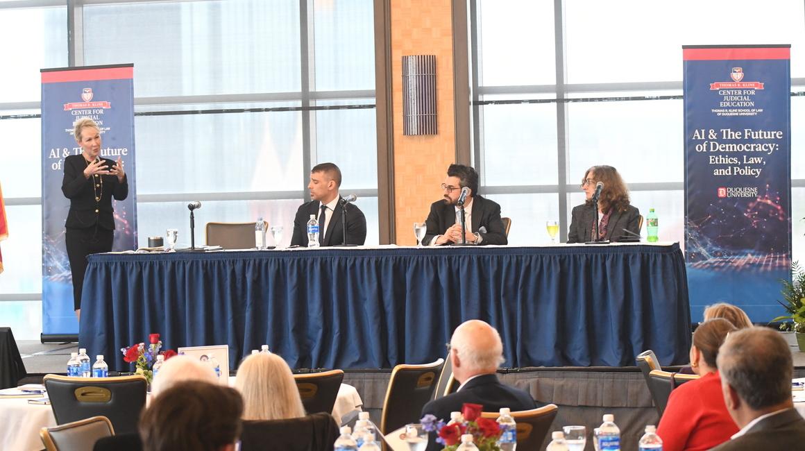 Dean April Barton presents on stage at the AI & The Future of Democracy: Ethics, Law, and Policy CJE/CLE event hosted by the Kline Center for Judicial Education on April 10, 2024.