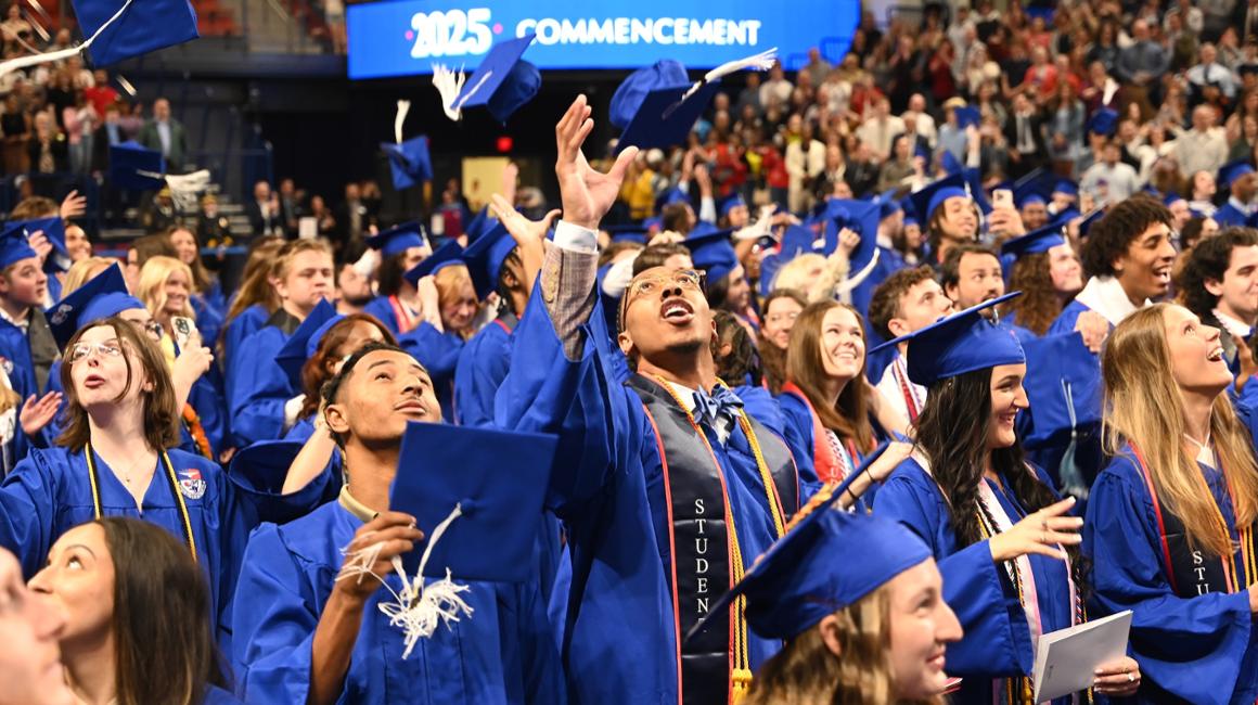 Graduates throwing their caps in the air