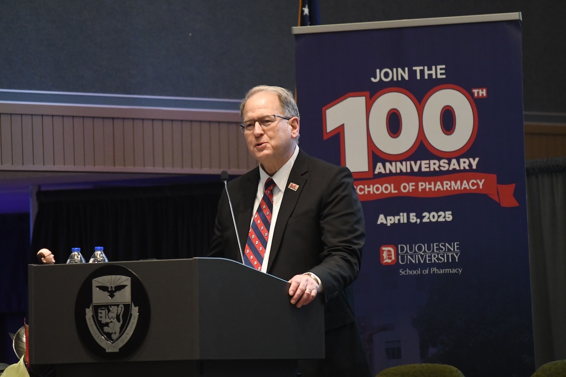 Drennen speaking at school's 100th anniversary