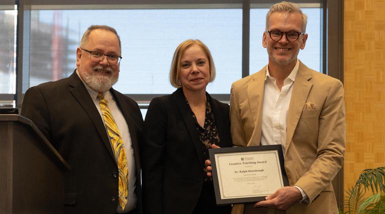 Dr. Ralph Klotzbaugh posing with his award and Associate Provost Darlene Weaver and Director of CTE, Dr. Steven Hansen.