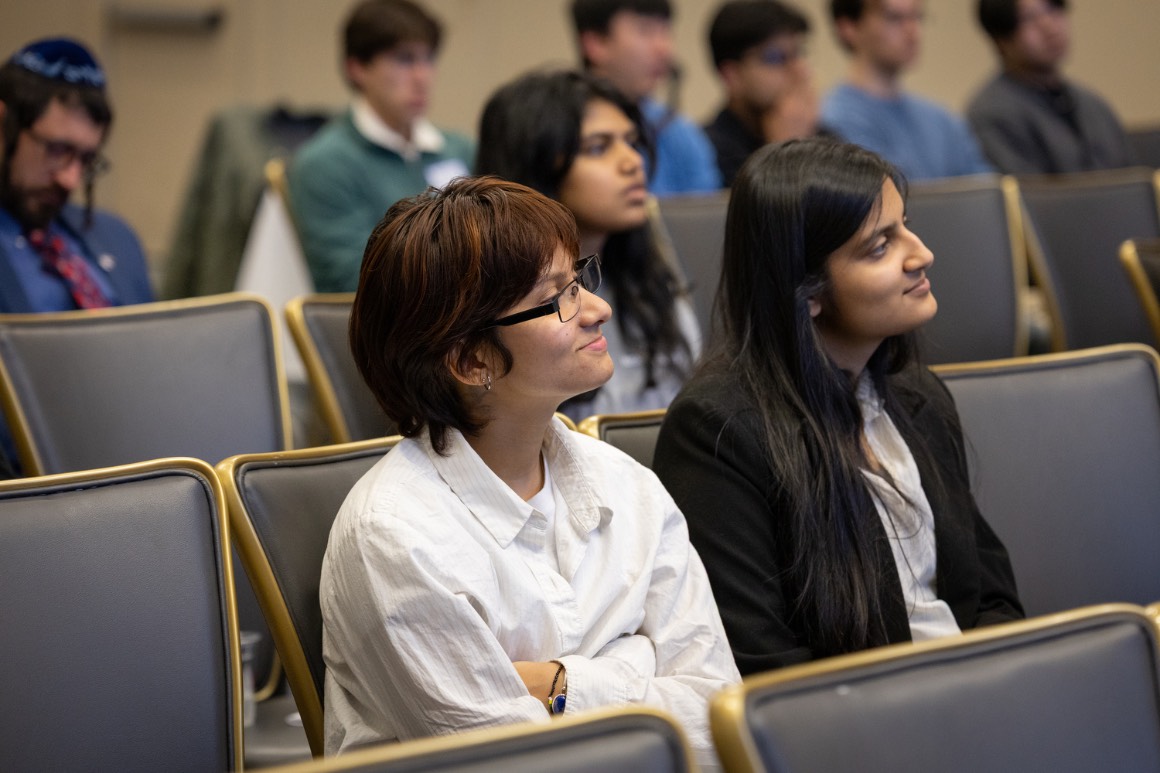 audience members listen attentively to a presentation at Hacking4Humanity 2026