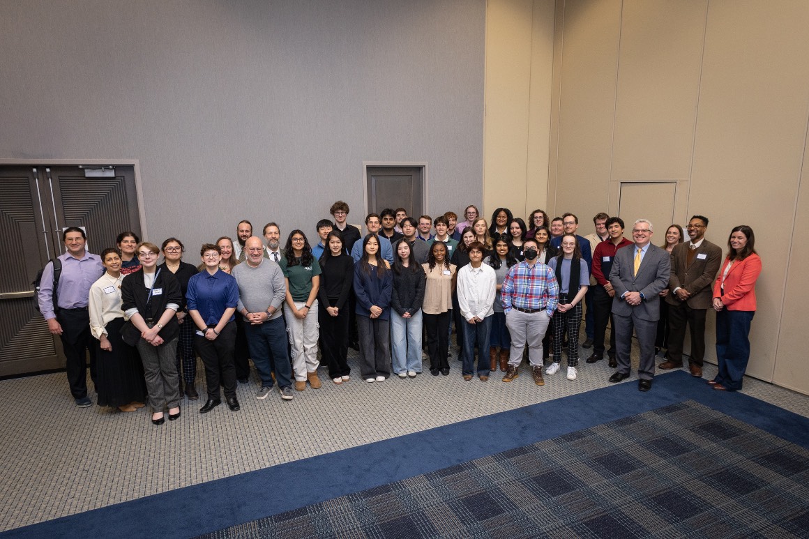 all participants, organizers, and judges pose for a group photo at Hacking4Humanity 2026