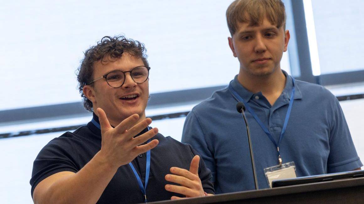Two students present their tech solution to combatting online hate at Hacking4Humanity 2025