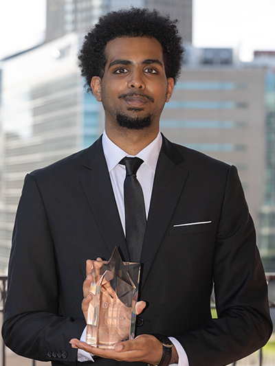 Dr. Ron L. Swain with 2026 winner Matthew Theodros