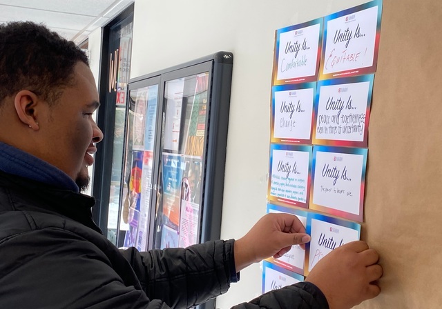 Duquesne student writing a message for the MLK Unity Writing Campaign Project