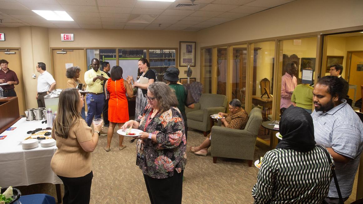 Attendees gathering and talking at the Juneteenth 2026 reception.