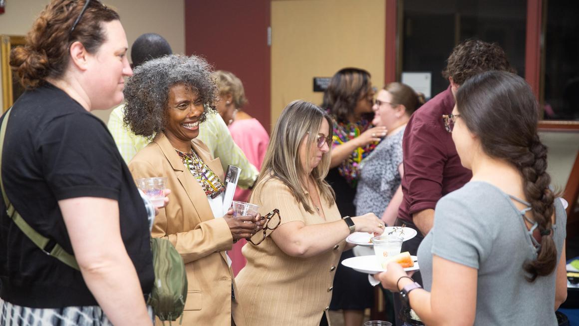 Attendees gathering and talking at the Juneteenth 2026 reception.