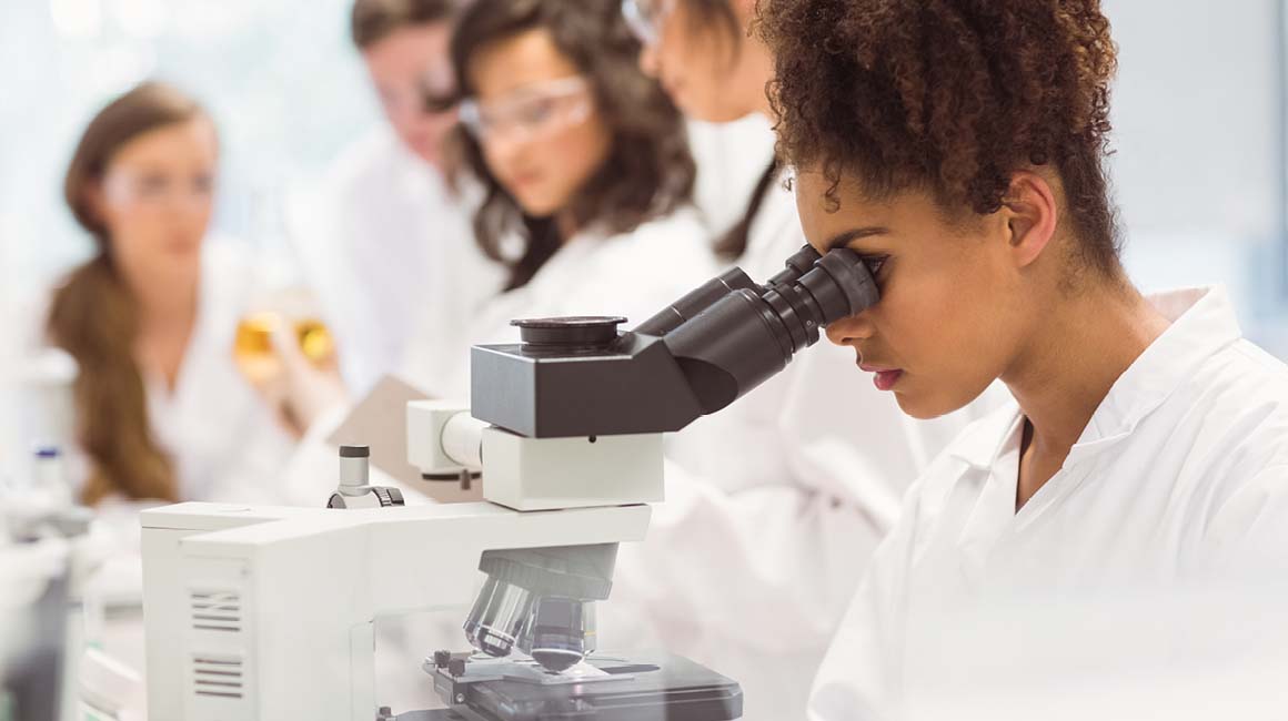 a picture of a girl using a microscope